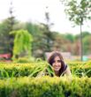 young girl hiding over bush