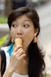 Portrait of a young Asian woman eating ice cream