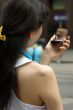 Young Woman with a lipstick mirror on the road.