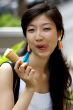 Portrait of a young Asian woman eating ice cream