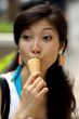 Portrait of a young Asian woman eating ice cream