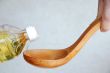 Pouring oil in wooden spoon