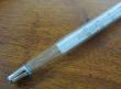 close-up mercury thermometer on wooden table
