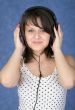 Girl in ear-phones on a blue background