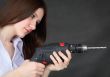 Young beautiful girl with drill in hands