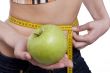 Waist is 65.5 centimeters.Woman measure tape apple