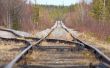 Old rusty tracks leaving afar to horizon