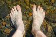 bare feet on shoal of lake