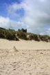 Castle partially hidden by the sand dunes.