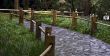 Stoned road with the wooden fence