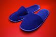 Blue slippers on red background