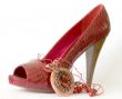 Red shoe with high heel and necklace
