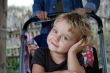 The thoughtful little girl in a carriage