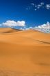 sand dunes and cumulus clouds