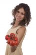 Smiling woman holding branch of red tomatoes