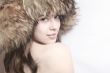 Portrait of the beautiful girl in a fur cap .