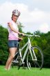 Girl standing with a bicycle