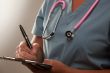 Abstract of Doctor Writing on Clipboard