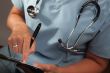 Doctor Writing on Clipboard