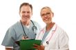 Male and Female Doctors Looking Over Files