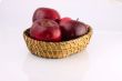 Red apples in a wicker plate