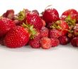 strawberry and wild strawberry on the table with shadows