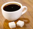 Espresso cup with pair of sugar on the wooden table