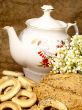 Delicious peasant bread with teapot and flowers