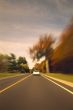 Automobile Driving Down Scenic Country Road