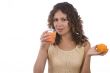 Woman is drinking orange juice.