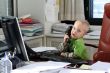 Little boy speaking on phone in the office