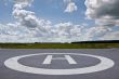 Helipad in the field in cloudy day.