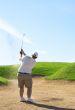 Golfer in the sand bunker