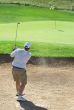 Golfer in the sand bunker