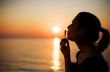 girl making soap bubbles over sunset