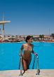 The beautiful model poses near pool