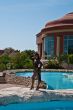 The beautiful model poses near pool