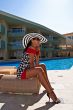 The beautiful model poses near pool