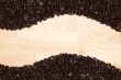 Dark Roasted Coffee Beans on Wood Background
