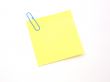 Yellow sticky note and paper clip