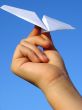 child hand with paper plane