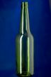 Green Glass bottle on blue