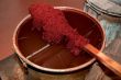 Coloured sheep`s wool into a colour pot