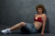 woman in red brassiere on grey wall