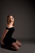 sitting young blonde in black dress looking up