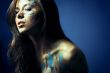 girl with bodyartposing on blue