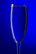 On blue background champagne glasses macro