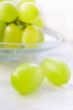 Green ripe grapes in plate