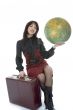 Beautiful brunette with valise and globe