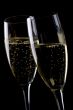 Two glasses champagne on black